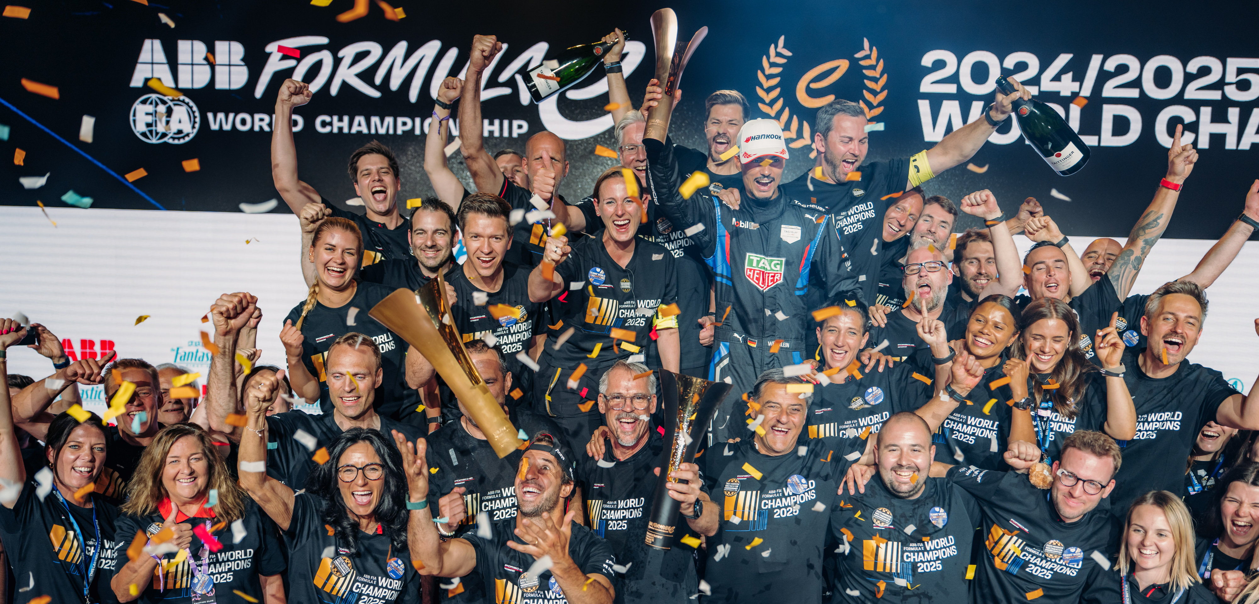 A group of people celebrating at the Formula E world championship.