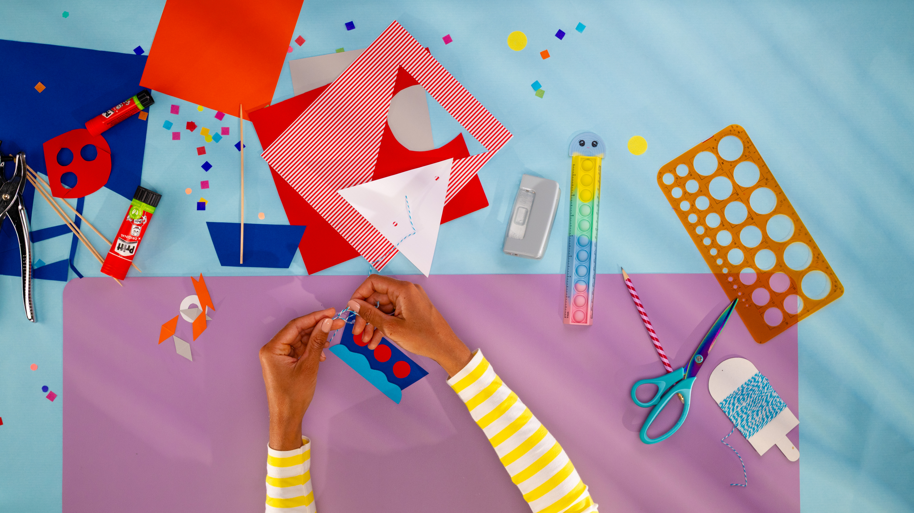 A person utilising a Pritt glue stick to create paper crafts