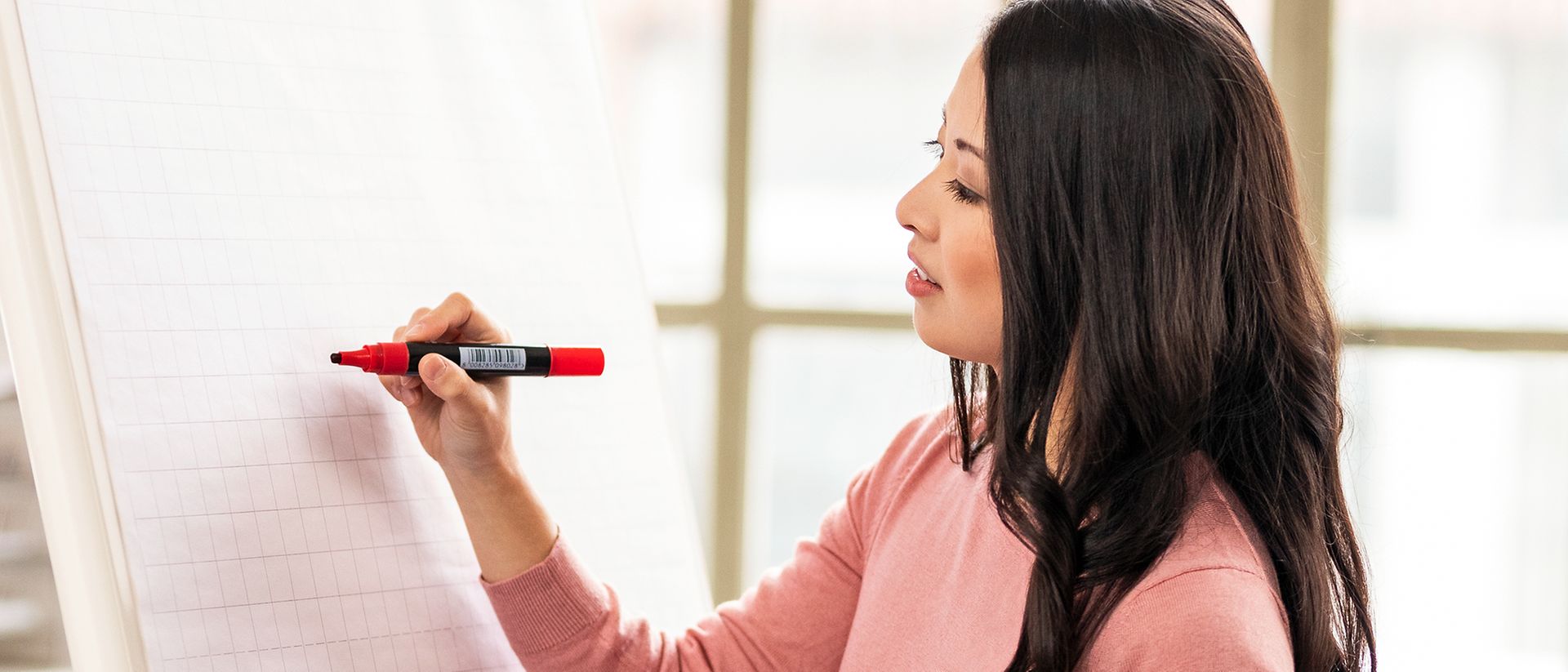 Woman with pen on a whiteboard