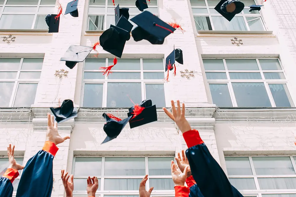 graduates throw their hats into the air