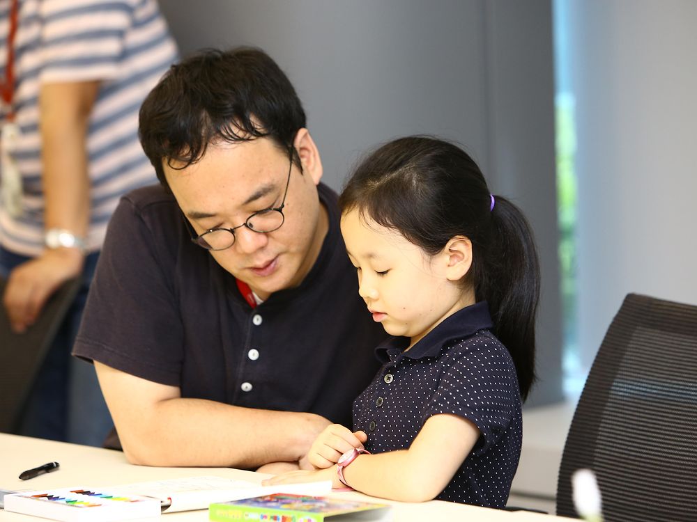 Edward Bae and his daughter Kunhee painted in a sustainability worksheet during class