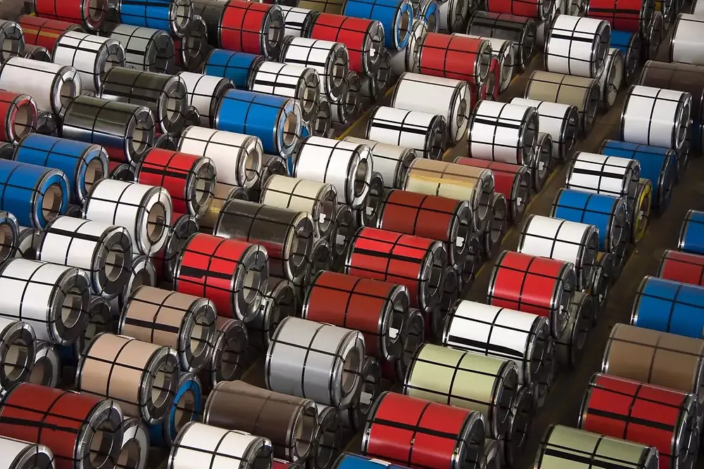 Close-up view of stacked metal coils in an industrial warehouse.