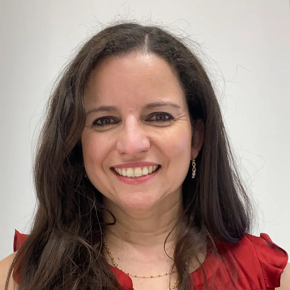 A portrait photo of Carolina Betancourt that shows her smiling into the camera.A portrait photo of Carolina Betancourt that shows her smiling into the camera.