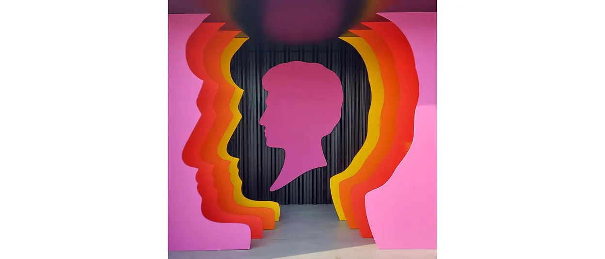 A wall with a three-dimensional Schwarzkopf head silhouette logo with different colours,