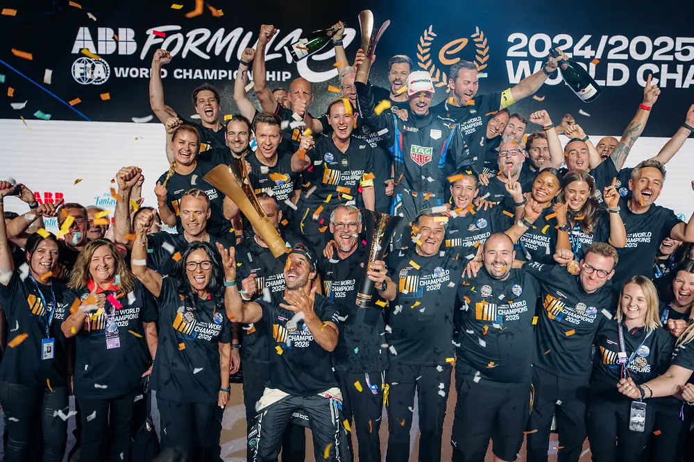 A group of people celebrating at the Formula E world championship.