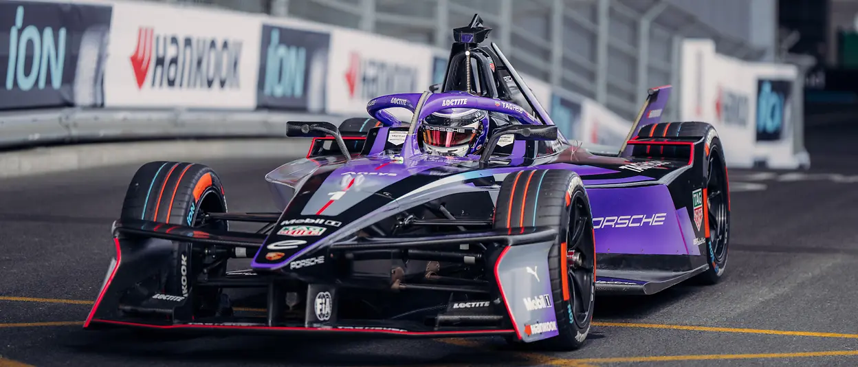 A purple electric race car on a race circuit.