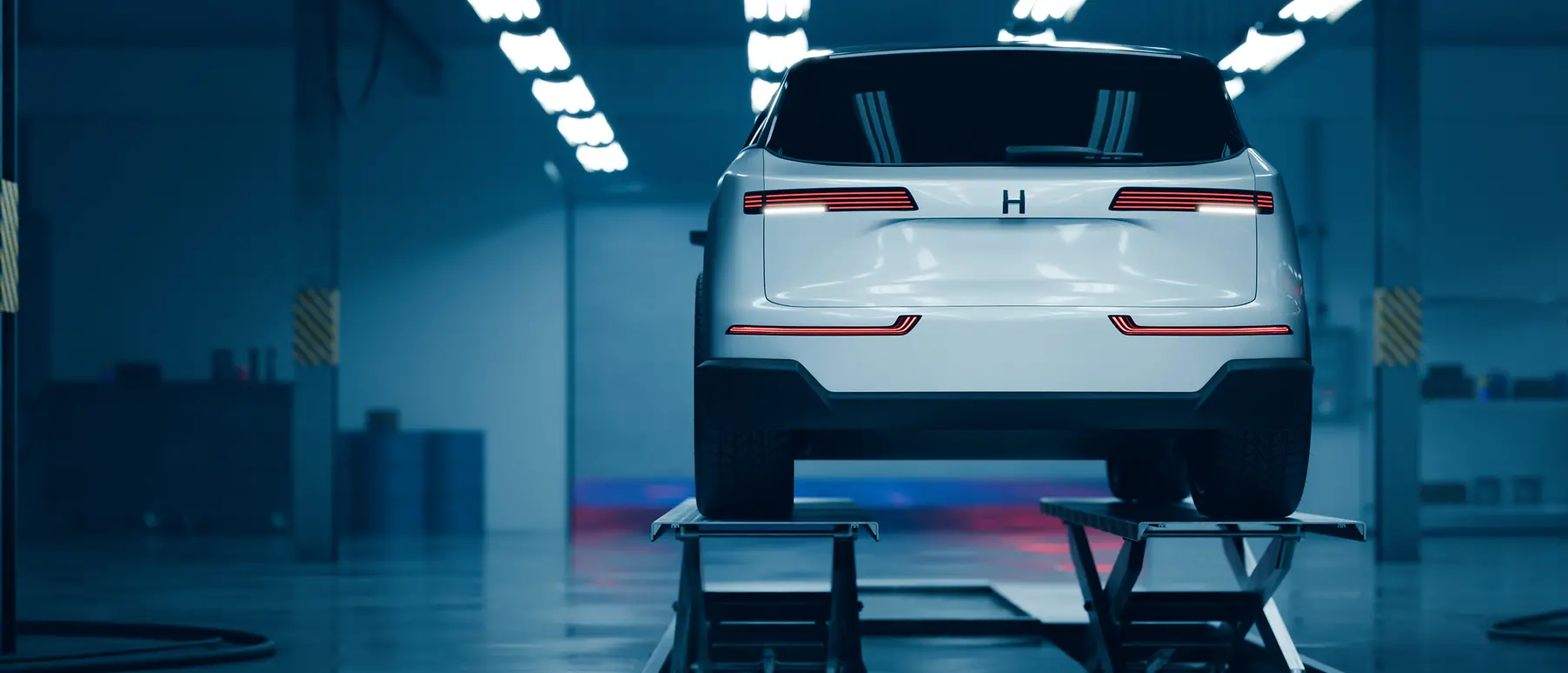 An image of an electric vehicle raised on a platform indoors