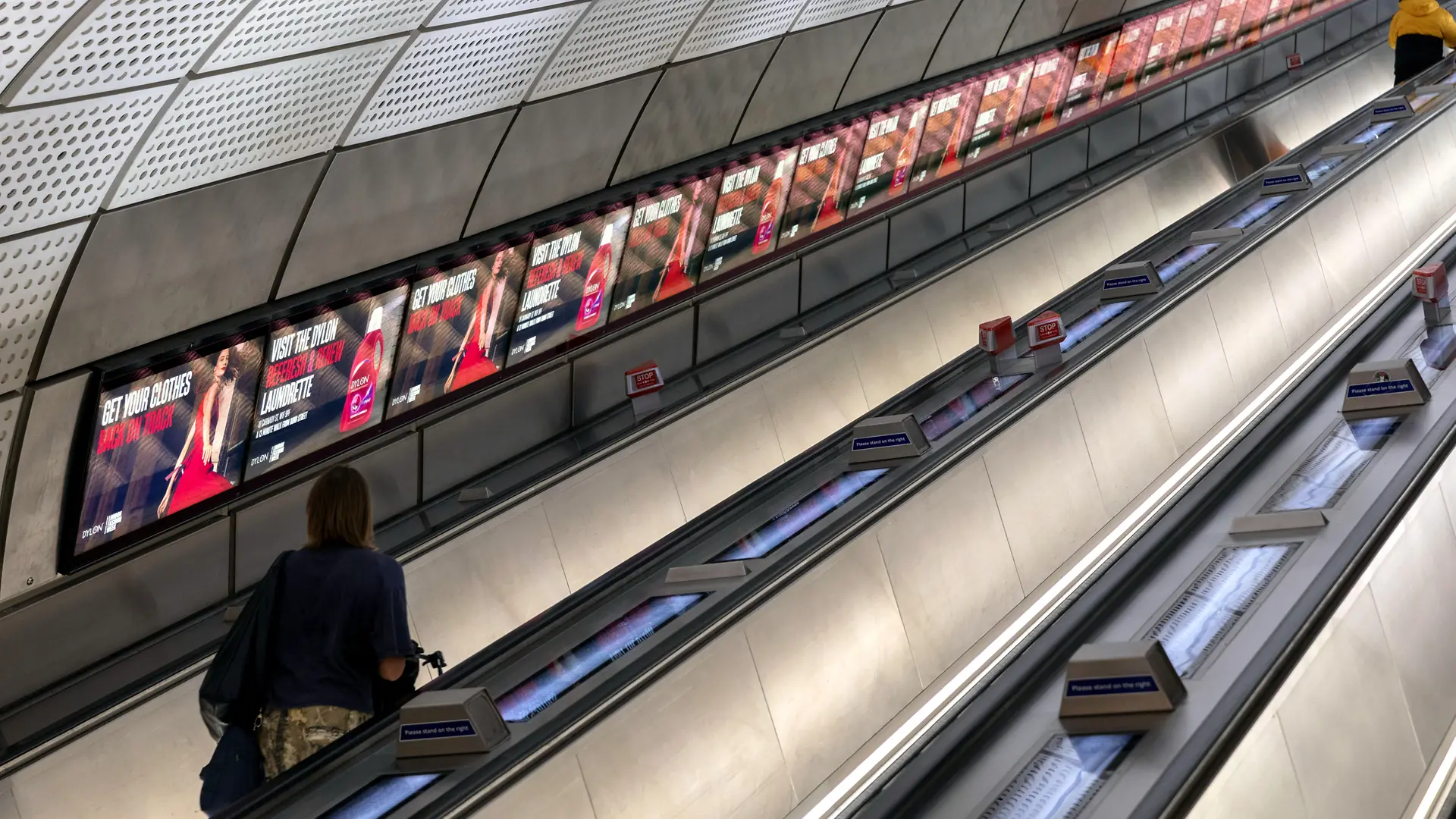 Dylon advertisements on the screens next to the escalator in the London Underground