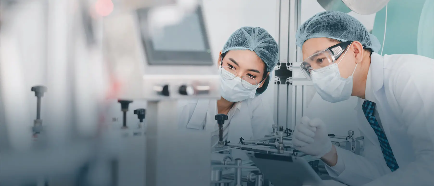 Two doctors in a lab assessing something in the distance