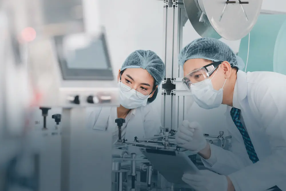 Two doctors in a lab assessing something in the distance