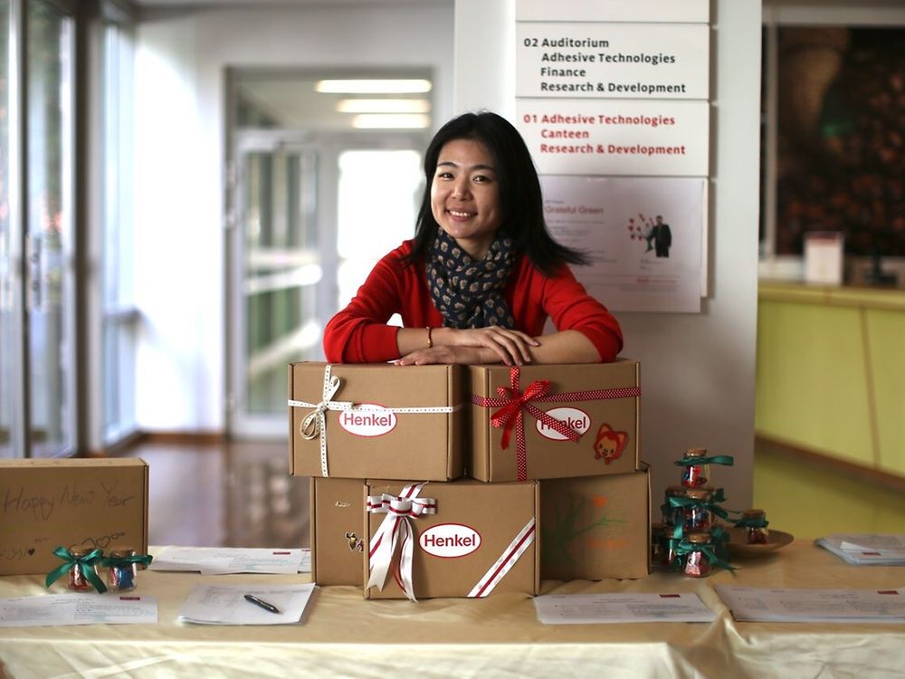 

Lucy Zhang with “Boxes of Love” which have already been packed and which are to be sent to children in need all over China for the Chinese New Year.
